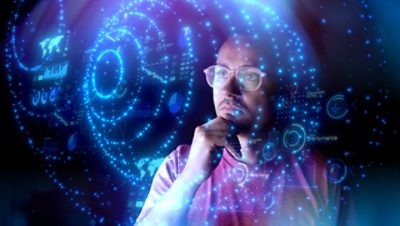Man looking at what looks like Death Star plans